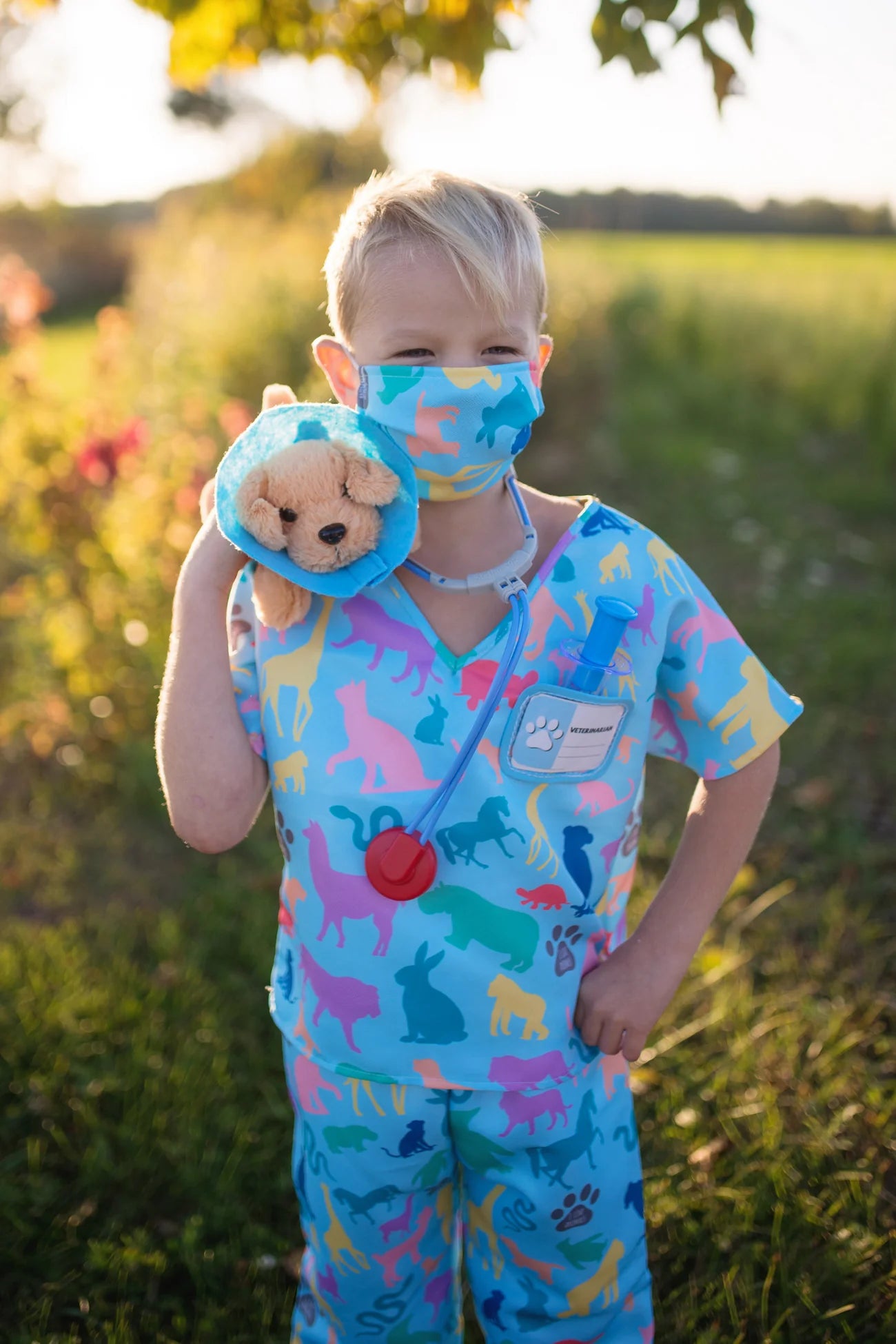 The vet is in! The adorable Veterinarian Set includes Scrubs: Shirt and Pants, Mask, Plush Puppy with removable Cone, Syringe with working plunger, Stethoscope, and a Name Card. Fully accessorized to play animal doctor your child will love taking care of plush animals! Taking care of your stuffed animals is the perfect way to nurture and develop compassion in young children, and it’s a fun and engaging way when suited up with these colourful animal print scrubs and realistic-looking accessories.