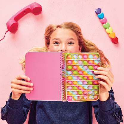 Bring on the good vibes and a splash of color with the Rainbow Tie Dye Popper Journal by Iscream. Perfect for teens and young girls, this journal features 120 lined sheets and measures 5 3/4" w x 7" h. Express yourself with style and positivity!