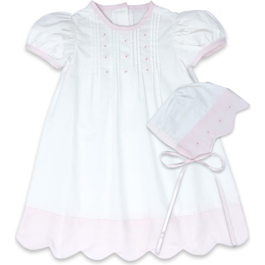This 1956 Daygown set in white and pink scallop batiste with pink embroidery knots and bonnet is perfect for her most special first occasions and can be passed down with love to future generations.

Material:

100% Cotton
