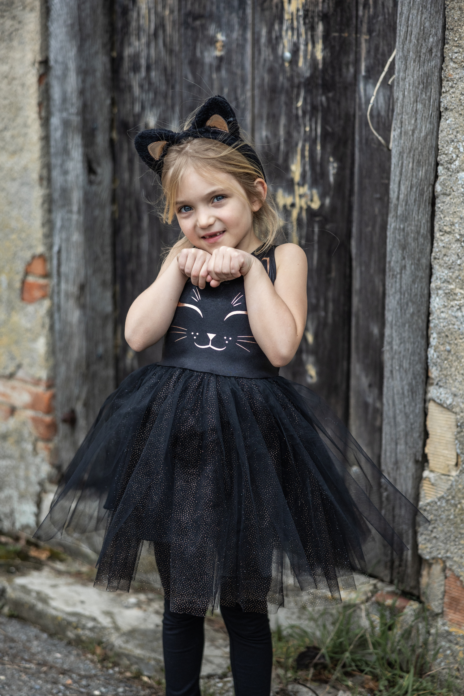 Our new Black Cat Dress &amp; Headband is the purrfect ensemble for your little feline aficionado! The dress features a sleek black design adorned with a charming cat face printed in shimmering rose gold on the chest. Its skirt dazzles with golden heat-sealed sparkles, adding a touch of glamour to every twirl. And what&