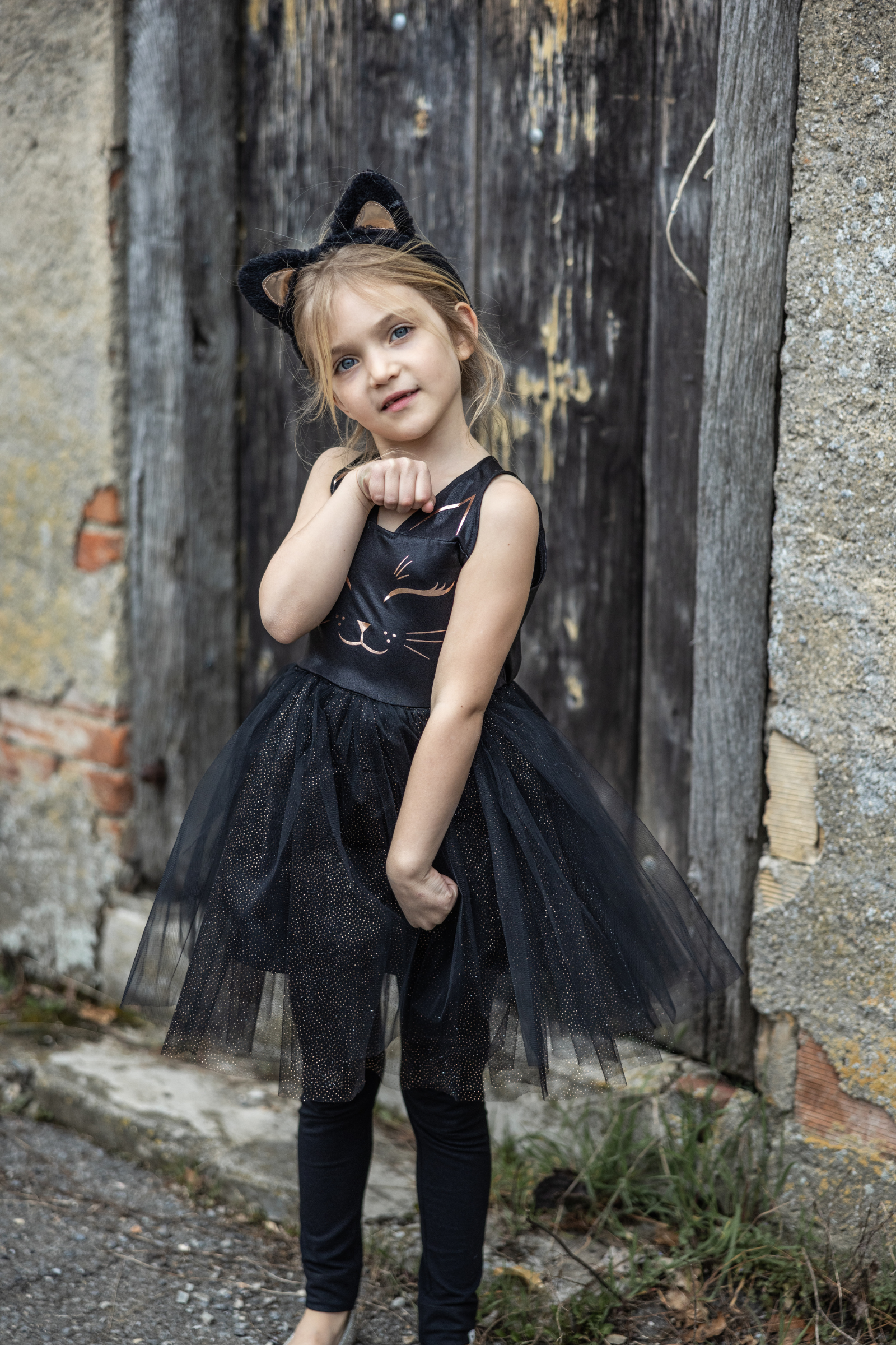 Our new Black Cat Dress &amp; Headband is the purrfect ensemble for your little feline aficionado! The dress features a sleek black design adorned with a charming cat face printed in shimmering rose gold on the chest. Its skirt dazzles with golden heat-sealed sparkles, adding a touch of glamour to every twirl. And what&