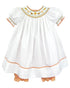 A sweet and stylish dress that is perfect for everything fall, from Halloween to Thanksgiving to any special occasion!

Our harvest bishop smocked dress comes in a soft white fabric with floral smocking in   an orange fall color scheme. Matching orange check pantaloons complete this look. This short sleeve dress is made with a cotton-poly blend fabric that is lightweight, airy and machine washable for easy care!