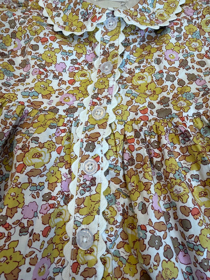 The Maggie Dress is all about timeless charm with a playful twist. Featuring a button-front design, soft floral print, and scalloped trim, it’s that picture-perfect piece made for every sweet moment this season.