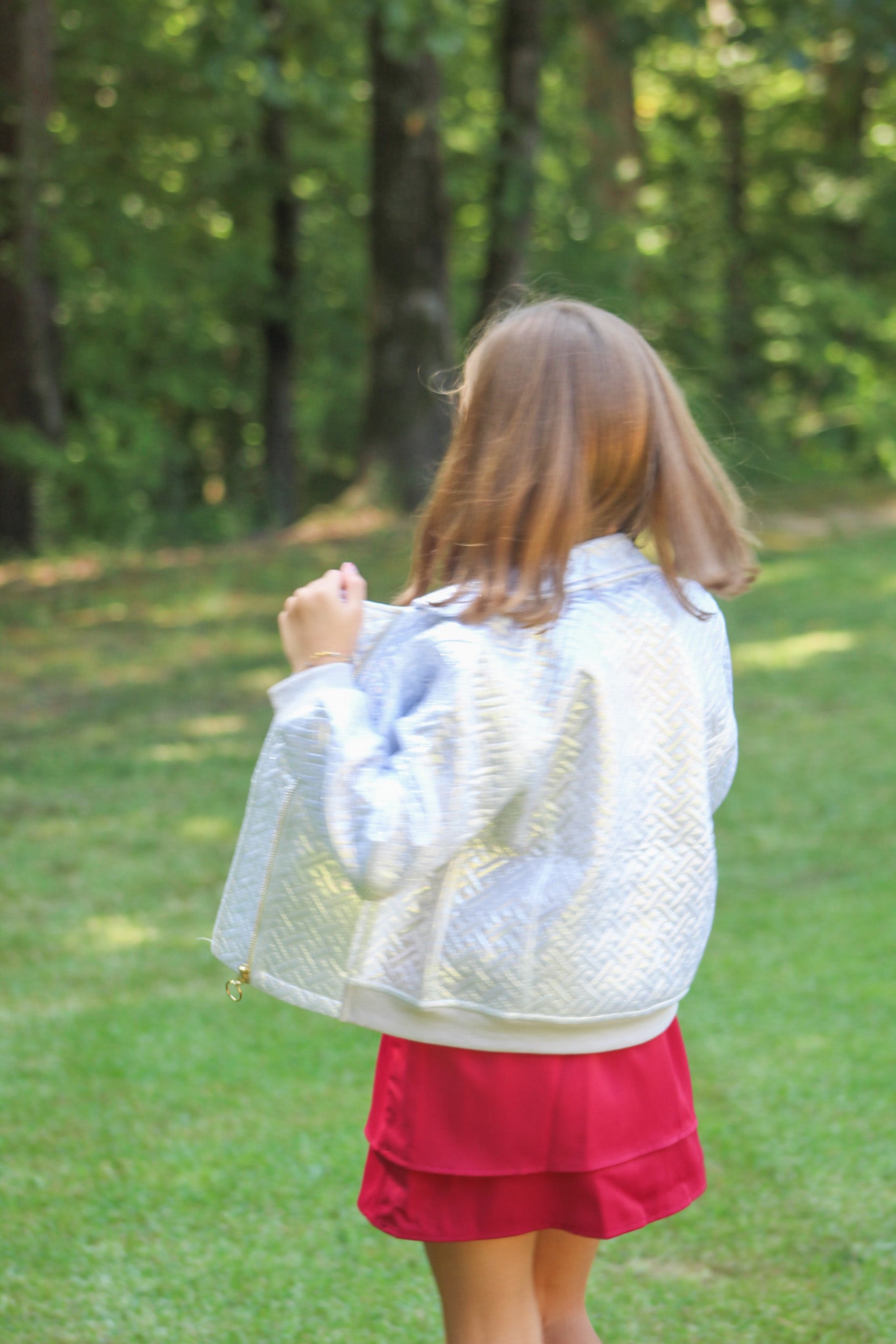 Delicate and dreamy, this silky dress is made just for girls who love a touch of elegance. It has soft pleats that gather gently at the neckline, creating a sweet, textured look. The bloused top flows beautifully over a fitted waist, introducing her to an appropriate and classic figure flattering look. Its comfy fabric makes it easy to move, twirl, and play—while still looking polished for special occasions or family celebrations.