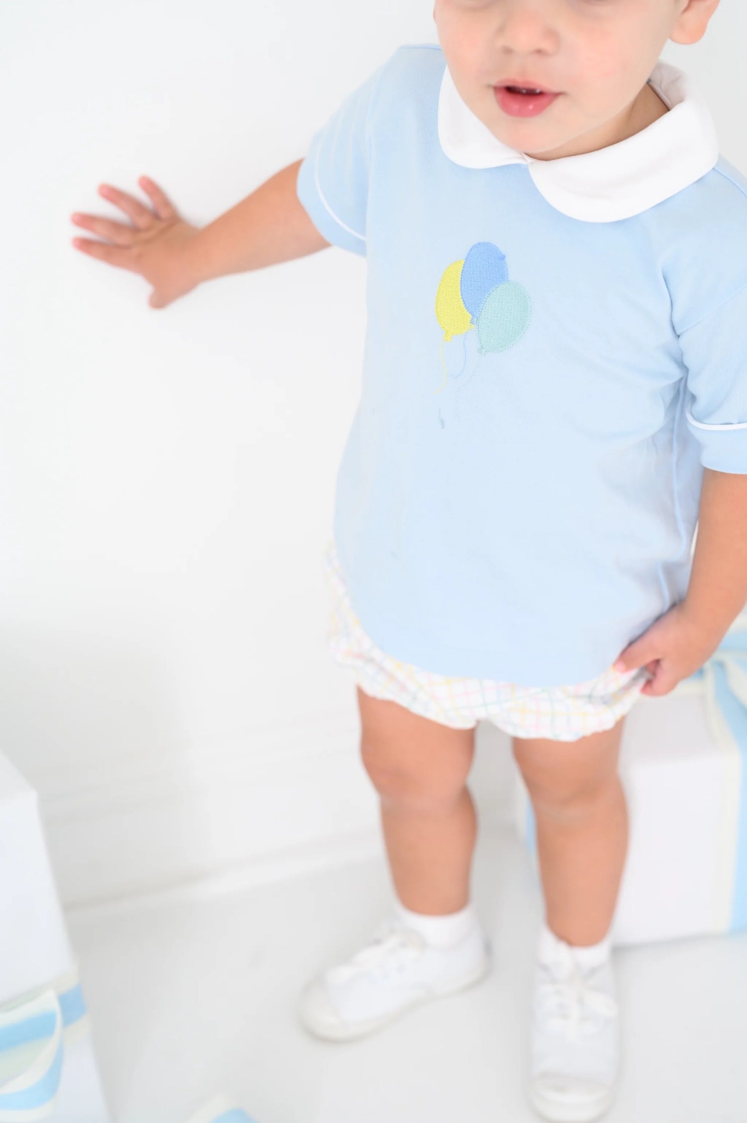 Bluffton blue knit top with white piping and balloon embroidery on the chest with custom party time plaid woven bloomers.