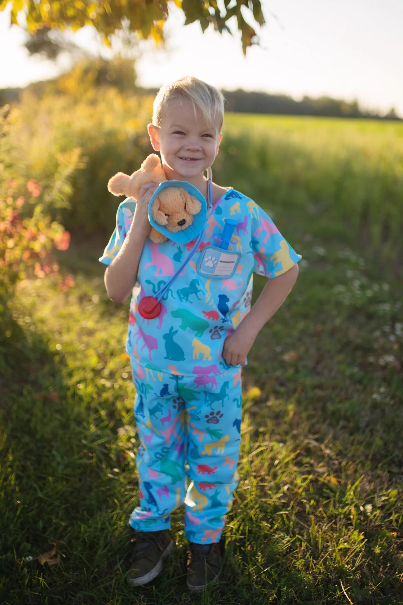 The vet is in! The adorable Veterinarian Set includes Scrubs: Shirt and Pants, Mask, Plush Puppy with removable Cone, Syringe with working plunger, Stethoscope, and a Name Card. Fully accessorized to play animal doctor your child will love taking care of plush animals! Taking care of your stuffed animals is the perfect way to nurture and develop compassion in young children, and it’s a fun and engaging way when suited up with these colourful animal print scrubs and realistic-looking accessories. 